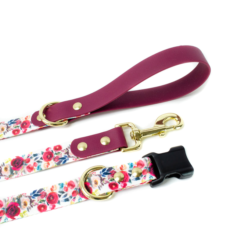 dog collar and leash with red and pink flowers. The handle is made out of Wine colored BioThane. All are made with solid brass hardware and YKK buckles