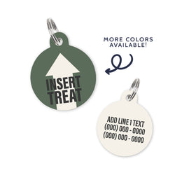 A hunter green colored dog ID Tag with dark grey text and white arrow stating a funny quote: insert treat